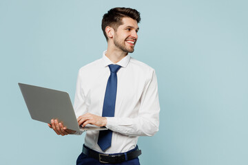 Young employee IT business man corporate lawyer wears classic formal shirt tie work in office hold use laptop pc computer look aside on area isolated on plain pastel blue background studio portrait. - obrazy, fototapety, plakaty