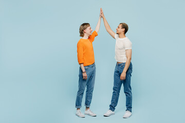Full body young couple two gay men wear casual clothes meet together greet give high five clapping...
