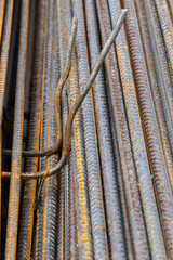 stacked rusty metal bars in construction
