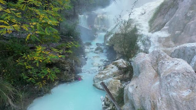 This aerial drone video shows the Bagni San Filippo. It is a hot spring which can be found in Tuscany, northern Italy. The relaxing hot springs are free to visit and have really hot water. 