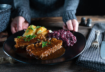 Meatloaf with gravy, red cabbage and potatoes. Traditional german cuisine