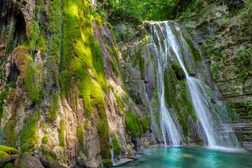 Scenic waterfall on the Italian mountains. Cascate gemelle (twins waterfall) close to Faedis village, Udine province. The beautiful nature of Friuli Venezia Giulia region, Italy.