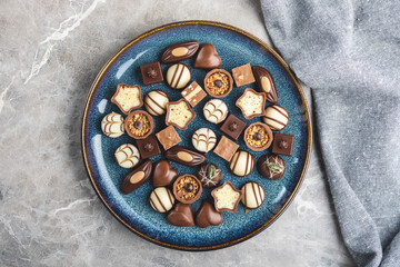 Sweet chocolate pralines.  Tasty chocolate truffles on plate. Top view.