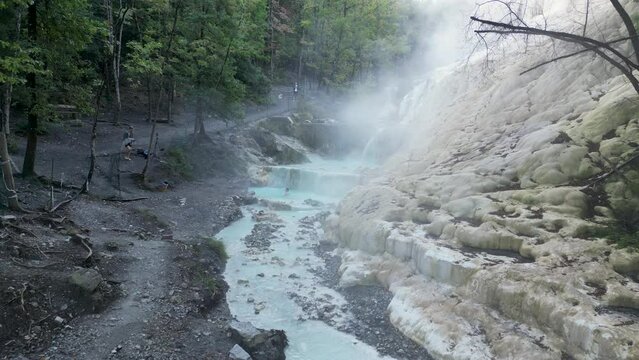 This aerial drone video shows the Bagni San Filippo. It is a hot spring which can be found in Tuscany, northern Italy. The relaxing hot springs are free to visit and have really hot water. 