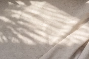 Fototapeten Beige linen fabric texture with folds and natural floral sunlight shadows, aesthetic summer wedding bohemian background © Viktoriia