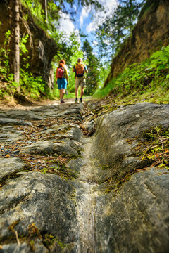 Austria, Tyrol,Hiking pair walking along ancient Roman road Via Augusta