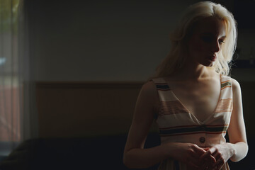 Thoughtful sad woman in darkroom