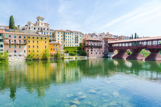 Italy, Veneto, Bassano del Grappa, River Brenta with buildings and Ponte Vecchio in background
