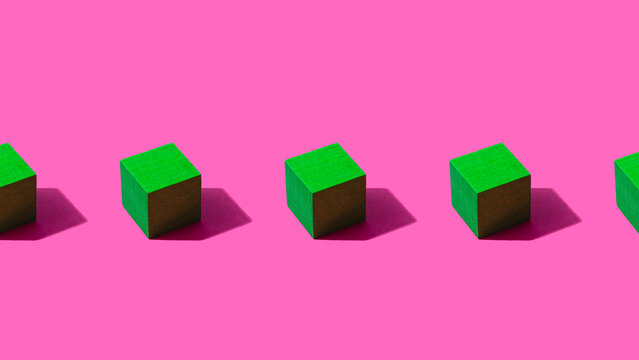 3D render of row of green cubes against pink background