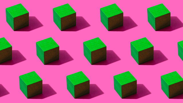 3D pattern of green cubes against pink background