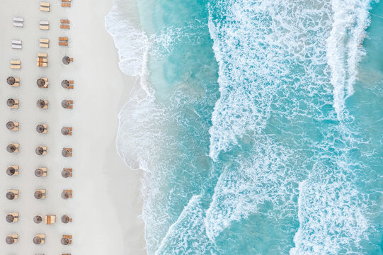 Spain, Balearic Islands, Formentera, Drone view of rows of umbrellas on empty beach