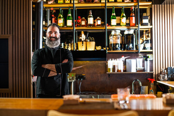Portrait of cheerful barmen at sushi restaurant.