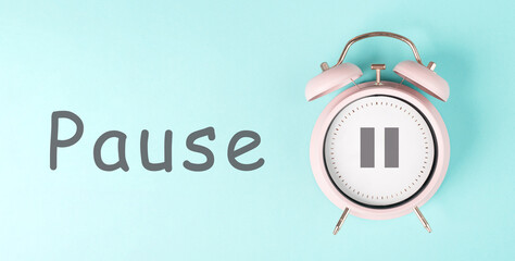 Alarm clock with pause sign, pastel color, time for a break, having lunch or a cup of coffee
