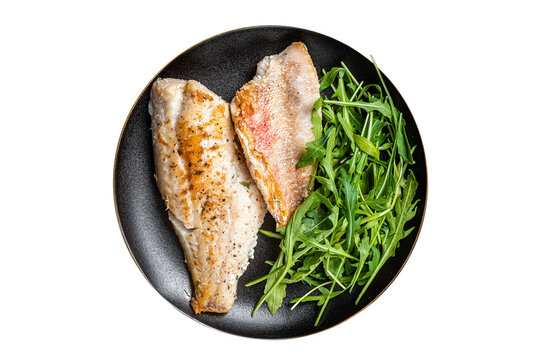 Roasted Snapper, sea red perch fillet on a plate with salad.  Isolated, transparent background.