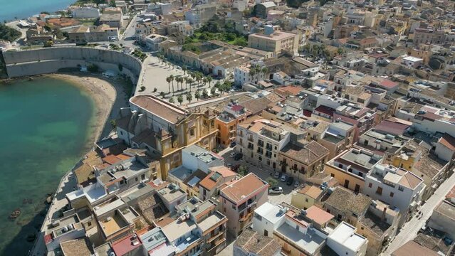 This aerial drone video shows the beautiful coastal city of Castellammare Del Golfo in Sicily, southern Italy. The city has old architecture and a marina wherefrom boats sail on the mediterranean sea.