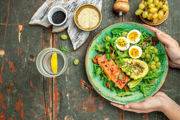Keto bowl salmon salad with greens, eggs and avocado. Ketogenic diet breakfast lunch. Top view