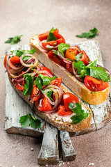 Tomato and cheese fresh made bruschetta. Italian tapas, antipasti with vegetables. banner, menu, recipe place for text, top view