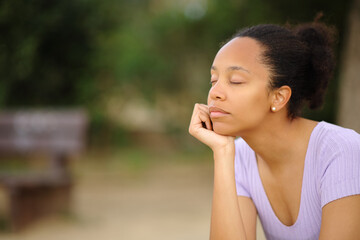 Black woman relaxing mind in a park