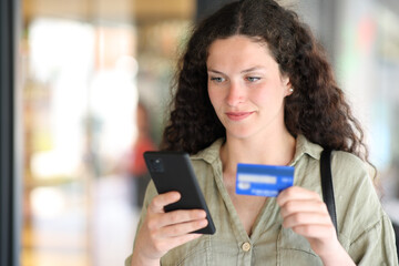 Woman buying online in the street