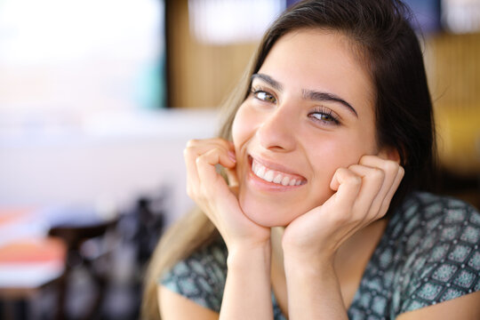 Happy woman with perfect smile in a restaurant