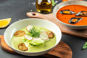 Assortment vegetable soups, tomato soup with mussels and zucchini. Food recipe background. Close up