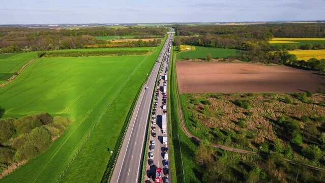 Traffic jam on A4 motorway in Poland due to an accident. Cars and trucks stopped on highway and fire truck moving among them, aerial view