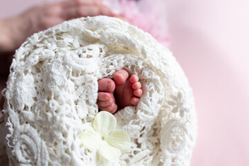 Fototapeta na wymiar Baby wrapped in a white lace swaddle