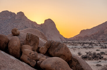 Fototapeta na wymiar Impression of the Rocky Namibian Desert near Spitzkoppe during the golden hour around sunset.