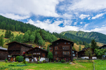 Ancient wooden traditional Swiss granaries and chalets on stone piles in an old abandoned village in Switzerland in mountains