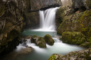 Obraz premium Waterfall with mossy rocks in mountain canyon in long exposure, Svrakava waterfall near Banja Luka