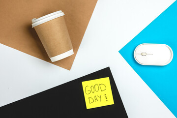 Paper cup, computer mouse and paper reminder, top view.