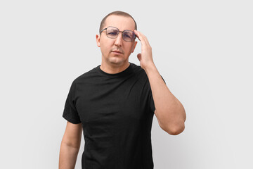 Young man having a headache on a white background.