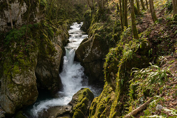 Fototapeta na wymiar Waterfall with mossy rocks in mountain canyon, Svrakava river near Banja Luka
