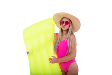 A blonde woman in a pink swimsuit and hat holds air mattress. Summer holiday