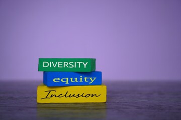 Wooden blocks with text diversity, equity and inclusion on table. Business concept