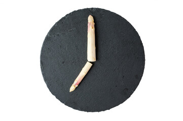 7 o'clock with asparagus tips on a round black slate plate