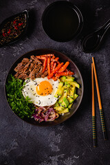 Traditional Korean dish Bibimbap: rice with vegetables beef and egg.