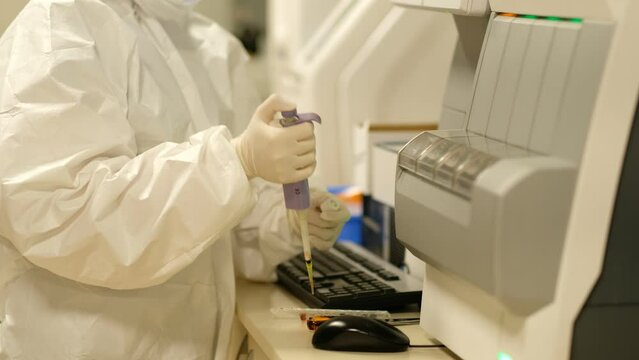 Profile of scientist testing test tube with blood sample to coronavirus