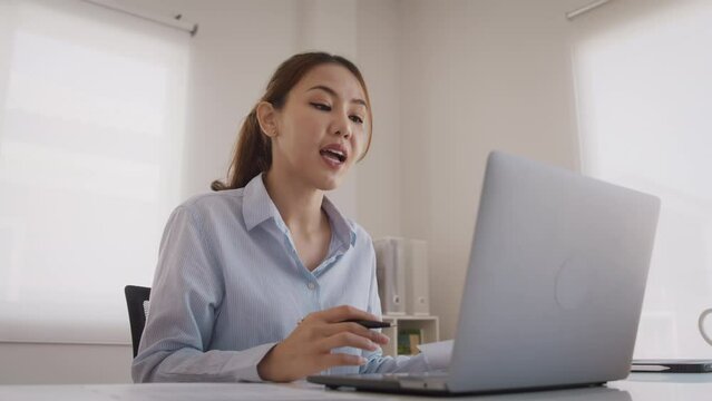 Bad Gen Z boss video call work argue point face stress yelling anger hate speech. Asia people woman fight on laptop videocall upset mad bossy. Online job issue mental health illness burnout at office.