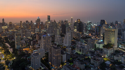 Fototapeta na wymiar Skyline panorama of Illuminated Bangkok city metropolis in twilight during the sunset. Panoramic cityscape urban of modern city on dusk. High-angle view