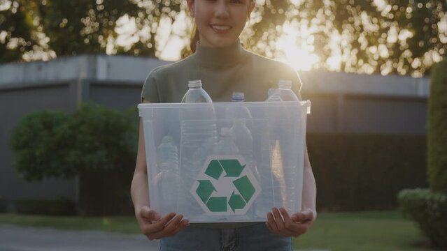 Save the planet reduce CO2 go green people carry bin box at outdoor nature, reuse recycle clean sort waste symbol. Global Earth protect day hope for future net zero eco friendly happy woman lifestyle.