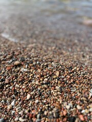 Natural sea pebbles, wet pebbles, small pebble background