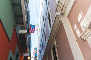 Puerto Rico Flag in alley Old San Juan Puerto Rico looking up