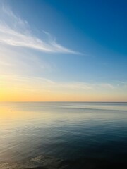 Blue sea horizon with some light clouds, seascape background