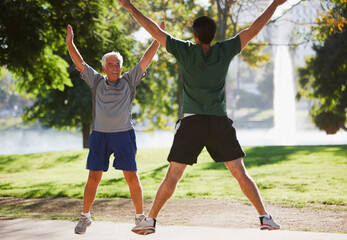 Older men doing jumping jacks outdoors - obrazy, fototapety, plakaty