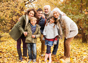 Family smiling together in park