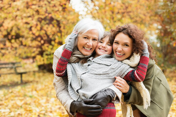 Three generations of women smiling in park