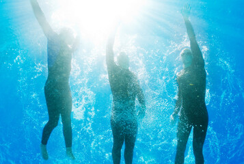 Athletes swimming underwater