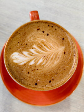 Top view of cappuccino coffee in a beautiful ceramic cup.