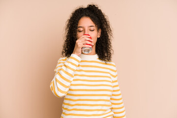 Young african american woman holding a cola isolated